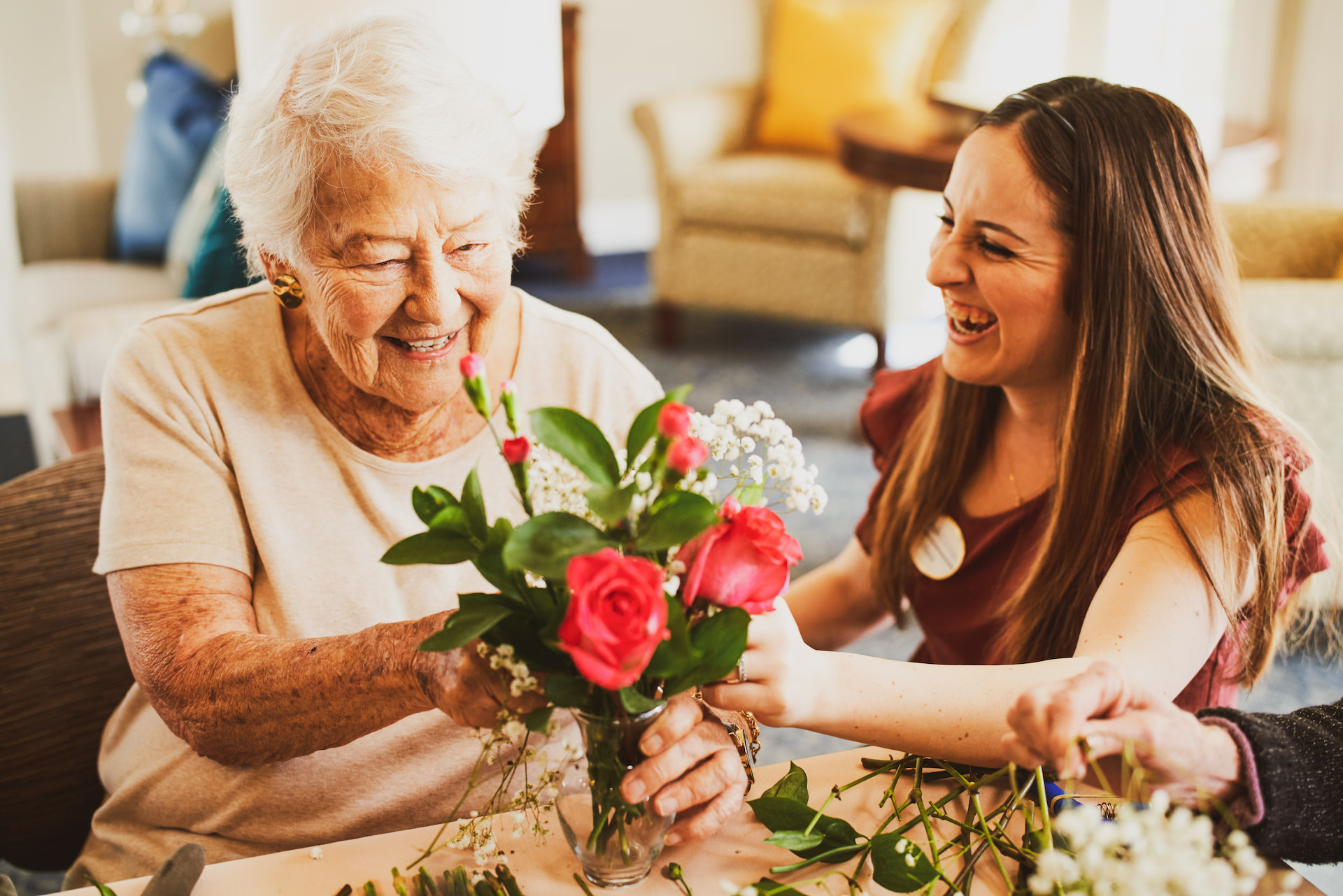 An resident making a bouquet of flowers with an employee