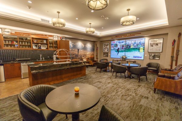 A bar area with tables and chairs