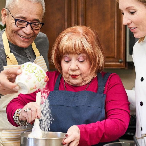 Two residents baking with a chef