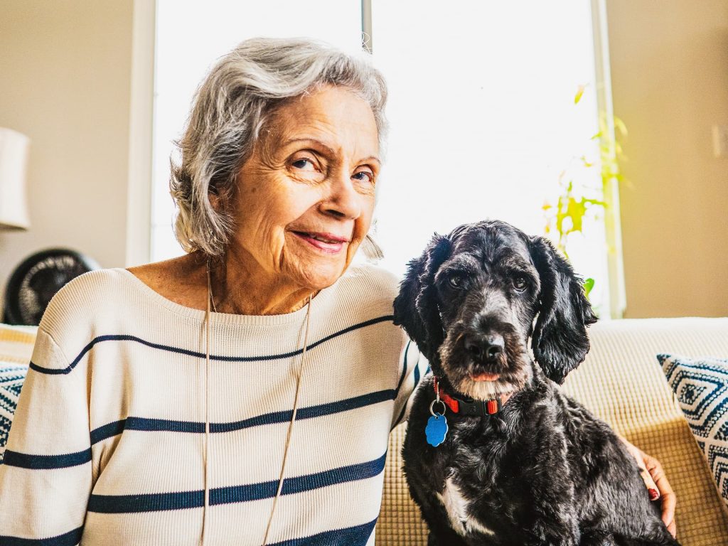 A resident sitting with her dog