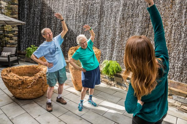 Two residents working out with an instructor