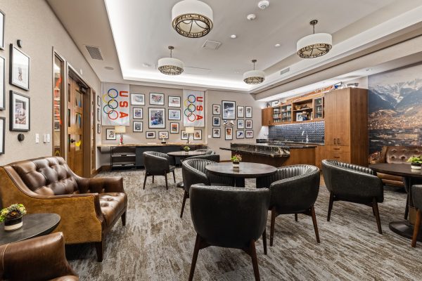 A seating area with tables and leather chairs