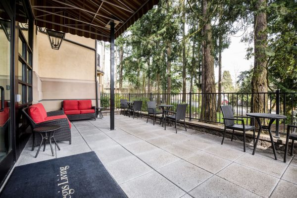 An outdoor seating area on the terrace with three sets of tables and two couches