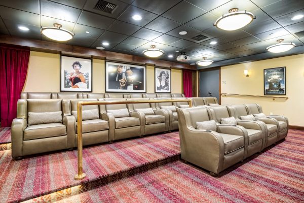 A movie theater room with lots of armchairs