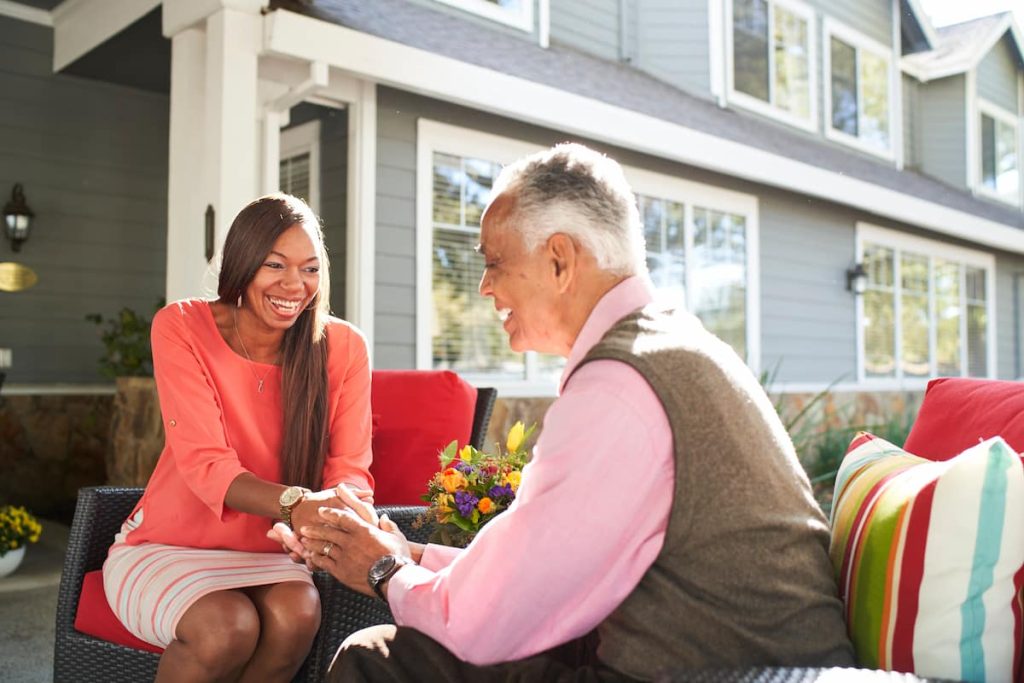 A resident with his granddaughter outside.