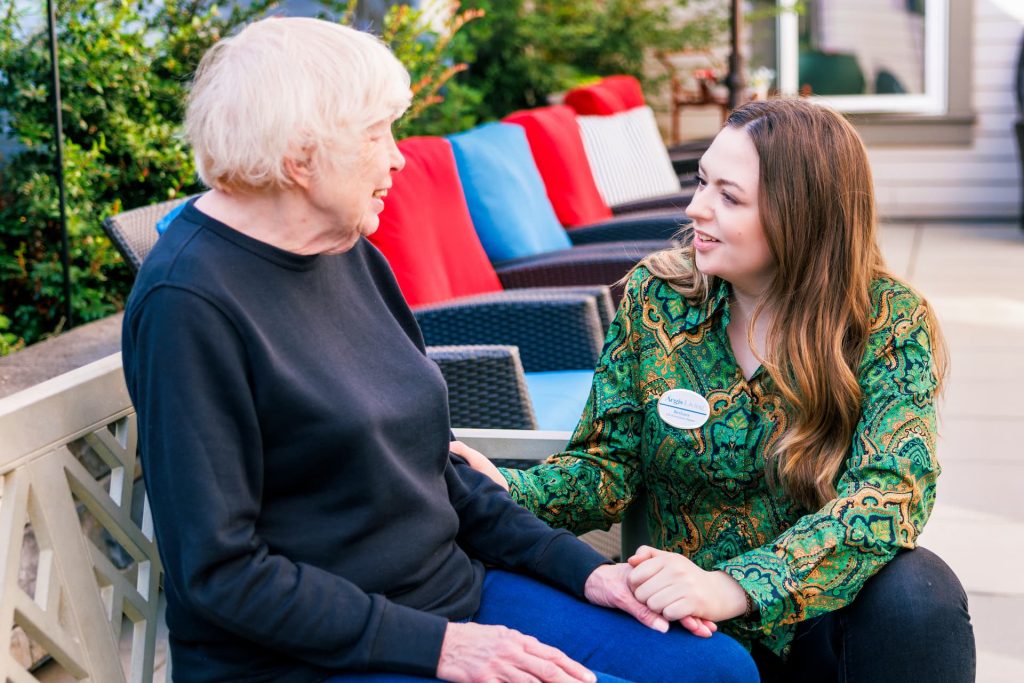 A resident talking to an employee outside