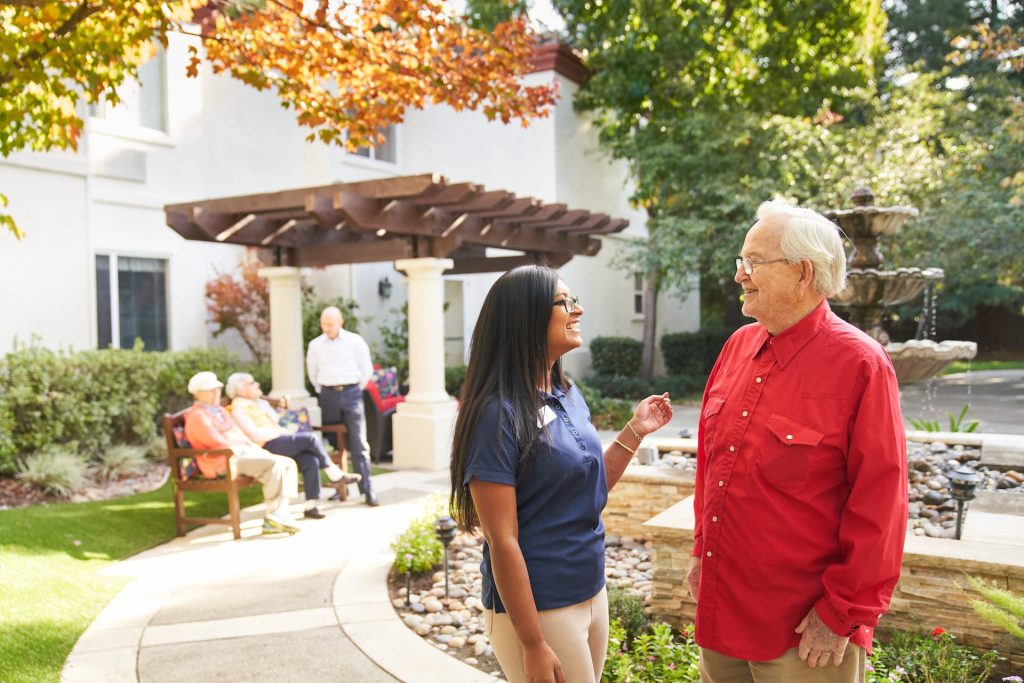 A resident talking to an employee outside