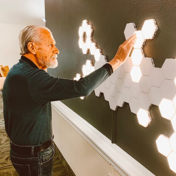 A resident touching a light-up art installation