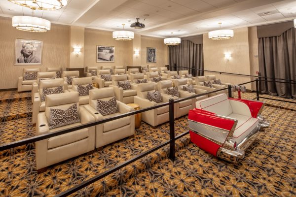 A movie theatre room with lots of comfortable seats.