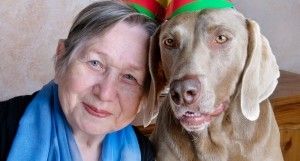 woman and her dog wearing birthday hats