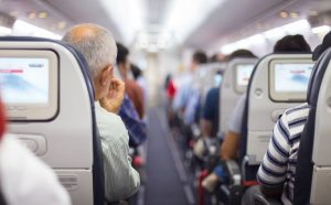 An elderly man sitting on plane