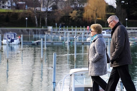 couple walking by marina