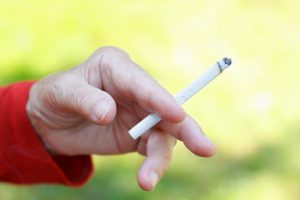 close up of a hand holding a cigaret