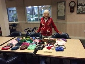 a women showing her knitted hats