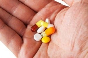 an open palm with various pills