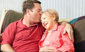 son hugging elderly mother