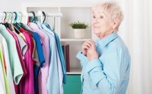 Senior choosing clothes from closet