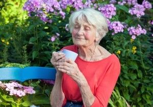 Woman holding coffee cup reacts to the aroma