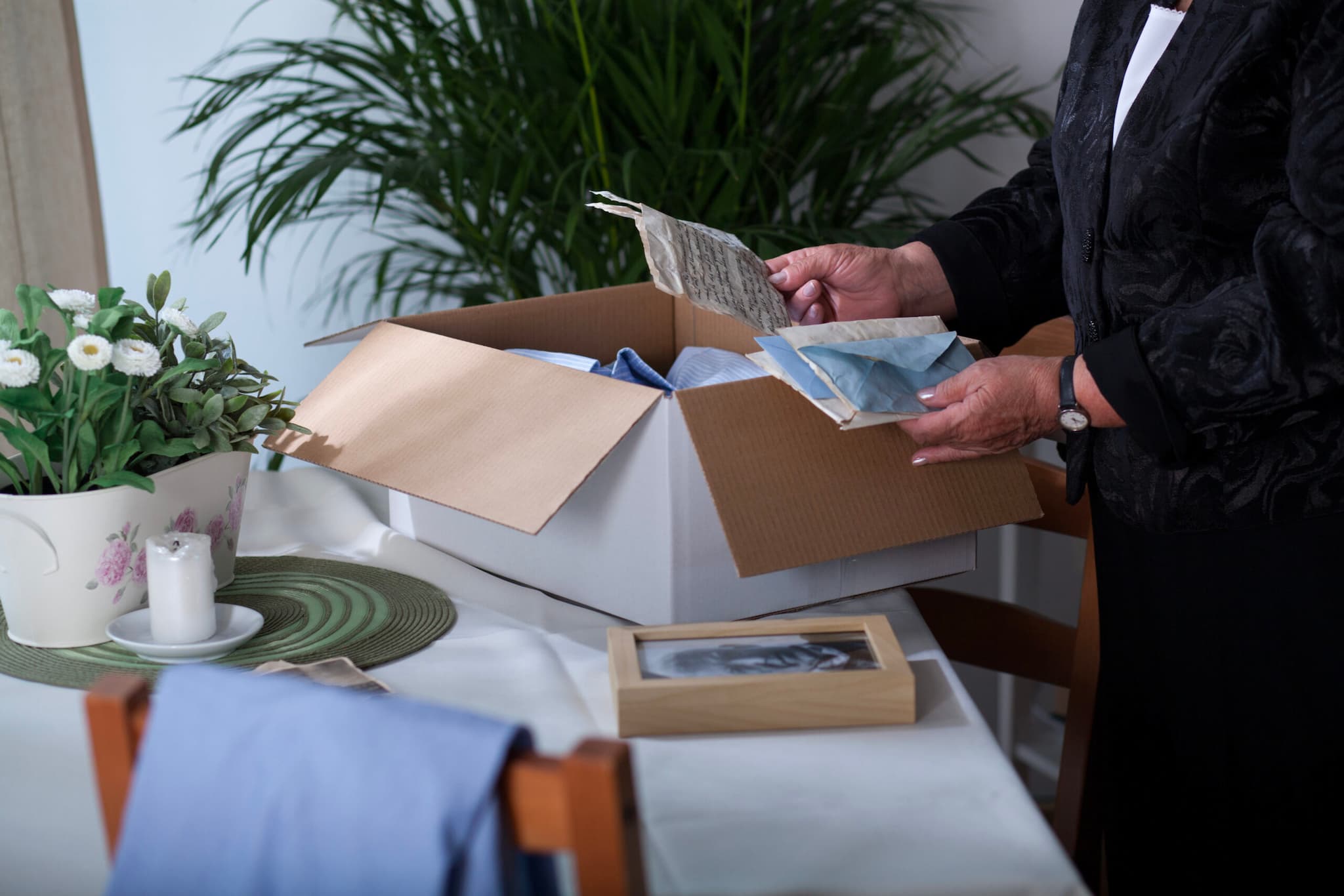 A person packing a box of papers
